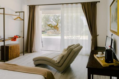 a bedroom with a chair and a large window at Luce in Magione