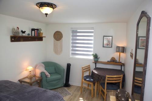 a bedroom with a bed and a table and a chair at Chalet Le Semeur in Saint Elie