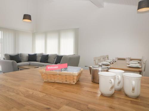 a living room with a table and a couch at Harcombe House Bungalow 3 in Newton Abbot