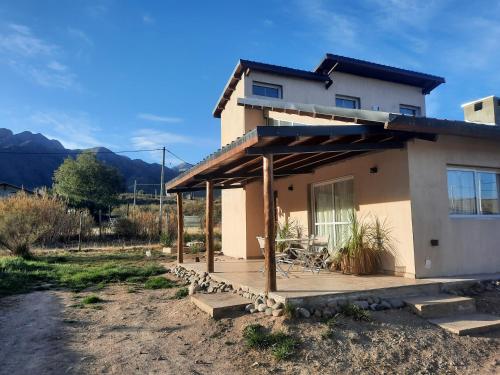 a house with a deck in front of it at Starry Lodge in Ciudad Lujan de Cuyo