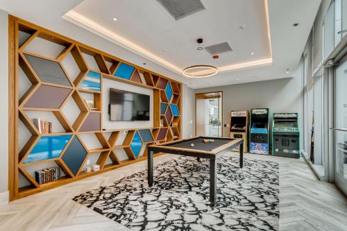 a room with a pool table and a wall with a tv at Sentral Michigan Avenue in Chicago