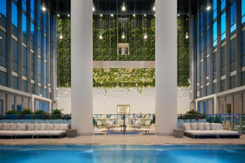 a lobby with couches and a fountain in a building at Sentral Michigan Avenue in Chicago