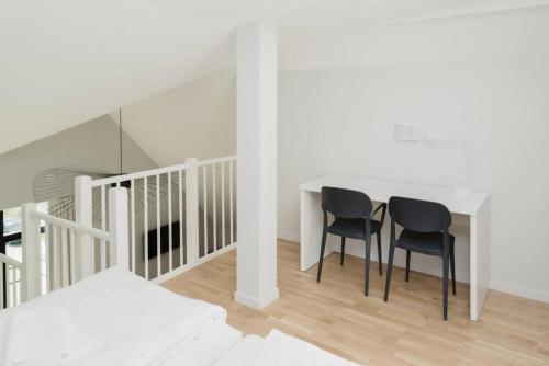 a dining room with a table and two chairs at SK67 Stylish and Full Equipped loft with free parking in Lidingö