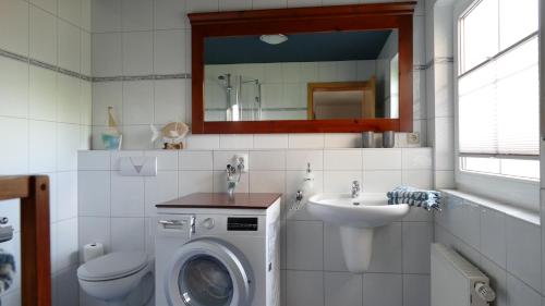 a bathroom with a washing machine and a sink at Ferienwohnung Eifelbergblick mit Garten, Schleiden, Wandern in the Eifel National Park, nähe Rursee in Schleiden