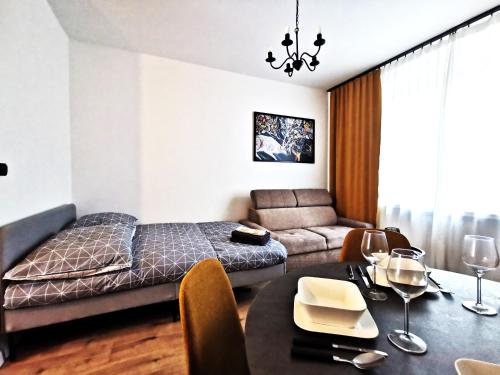 a living room with a bed and a table at PODWALE Apartment - Self Check-In 24h in Wrocław