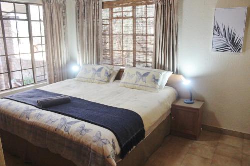 a bedroom with a large bed with two pillows at Nature Rest in Marloth Park
