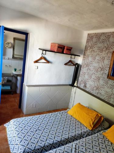 a small bedroom with a bed in a room at Casa14 in Frigiliana