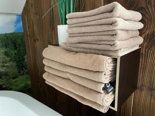 a stack of towels on a shelf in a bathroom at Alpin Haus Turrach in Turracher Hohe