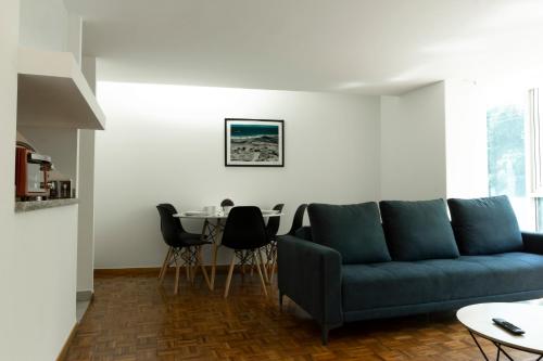 a living room with a blue couch and a table at Balsas By HomiRent in Mexico City