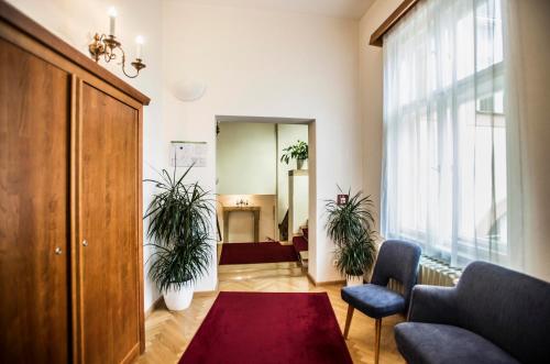 a living room with two potted plants in a room at Opitzův dům in Prague