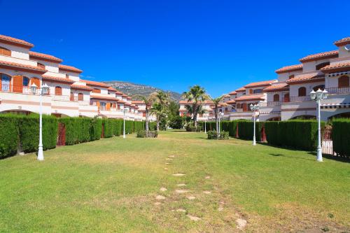 a large yard in front of some apartment buildings at UHC Arenal II Family Complex in Hospitalet de l'Infant