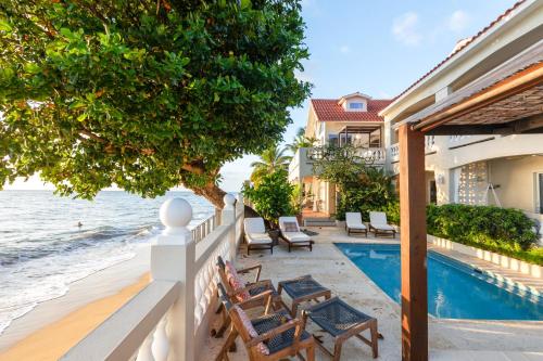 eine Villa mit einem Pool am Meer in der Unterkunft Tres Sirenas Beach Inn in Rincon