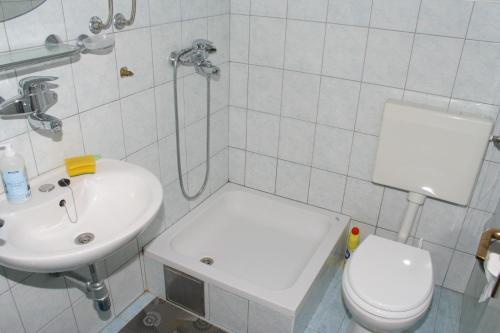 a bathroom with a toilet and a sink at Apartments by the sea Podgora, Makarska - 518 in Podgora
