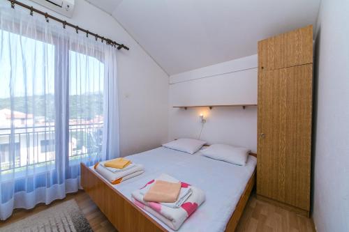 a bedroom with a bed with a large window at Apartments by the sea Podaca, Makarska - 516 in Podaca