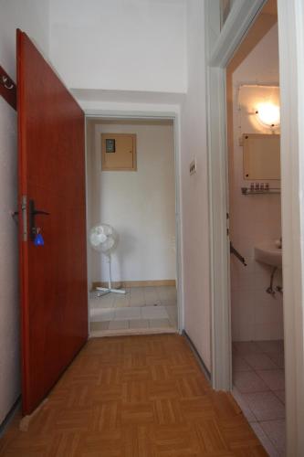 a hallway with a door and a bathroom with a fan at Apartments by the sea Luka - Dugi otok - 441 in Luka