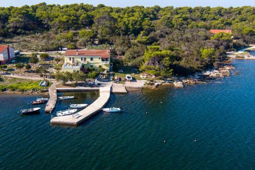 an aerial view of a dock with boats in the water at Apartments by the sea Veli Rat, Dugi otok - 438 in Veli Rat