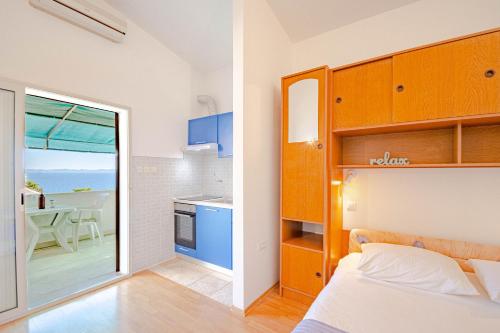 a bedroom with a bed and a view of the ocean at Studio Zavalatica 547a in Zavalatica