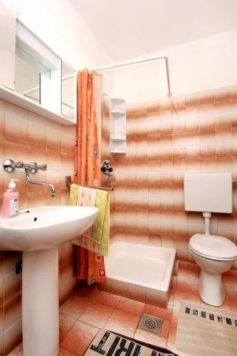 a bathroom with a sink and a toilet and a mirror at Apartments by the sea Zavalatica, Korcula - 546 in Zavalatica