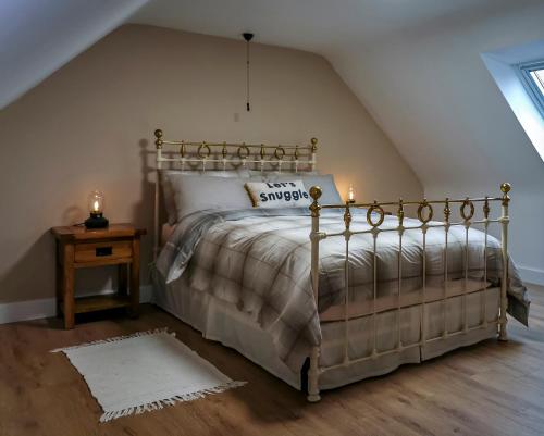 a bedroom with a bed with two candles on it at Kirkinner Cottage in Kirkinner