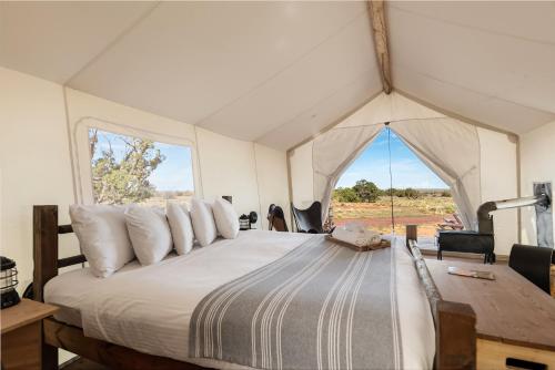 a bedroom with a large bed in a tent at Under Canvas Grand Canyon in Valle