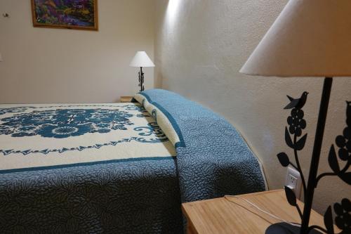a bedroom with a bed and a table with a lamp at Quinta Comala Hotel & Villas in Comala