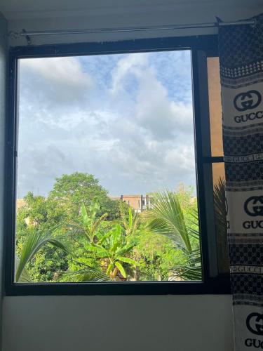a window with a view of trees and a building at keur manga2 in Somone