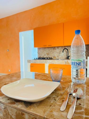 a table with a plate and a bottle of water at keur manga2 in Somone