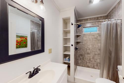 a bathroom with a sink and a shower and a mirror at The General in Lowell