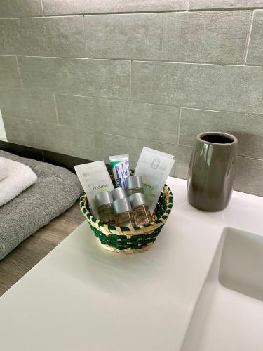 a basket of cosmetics sitting on a table next to a cup at il Giglio B&B in Asola
