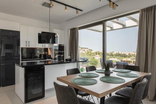 a kitchen and dining room with a table and chairs at Mystic Garden Villas in Zakynthos Town