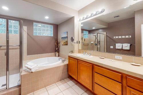 a bathroom with a tub and a sink at Ocean Pointe Lagoon #107 in Carlsbad