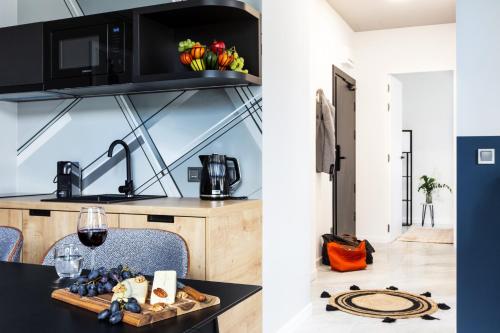 a kitchen with a table with a plate of food at H11 Aparthotel in Kraków