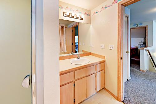 a bathroom with a sink and a mirror at Oliver Beach House in Seaside