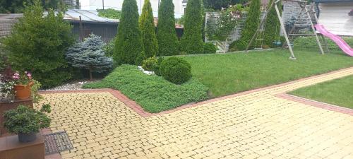 a backyard with a garden with a playground at Apartament Centrum in Wieliczka