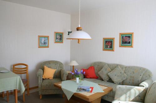 a living room with two couches and a table at Sternenhimmel in Klausdorf