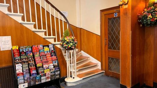 a staircase with a book display in a building at Gresham Hotel Bloomsbury in London