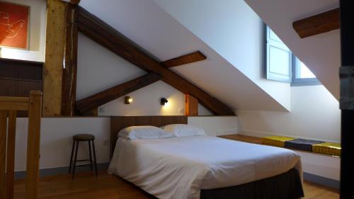 a bedroom with a white bed in a attic at Les Versaillaises in Versailles