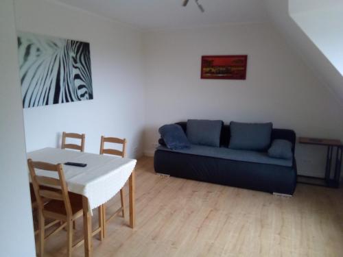 a living room with a couch and a table at Haus am Mühlenkämpchen - Schönblick in Radevormwald