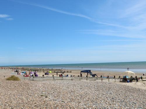 a group of people on a beach near the ocean at Flat 32 - Marine Court in Littlehampton