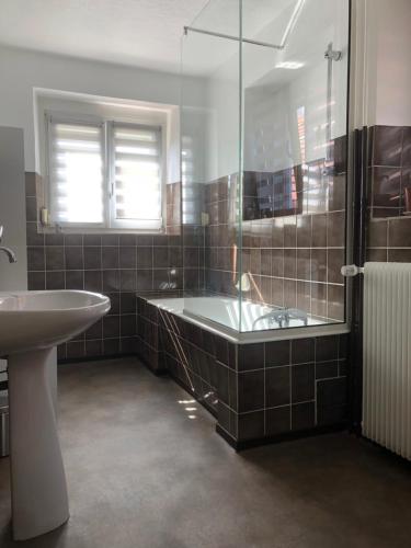 a bathroom with a tub and a sink and a shower at gîte de montagne au pied du Champ du Feu (Alsace) in Belmont