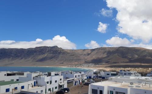 a view of a beach with white buildings and the ocean at Casa Salitre in Famara