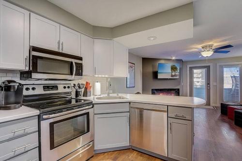 a kitchen with stainless steel appliances and white cabinets at WFC II Lake Access - Family or Romance - Location! in Wisconsin Dells