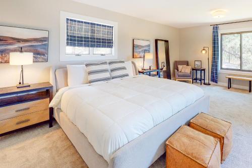 a bedroom with a large white bed and a desk at Mountain View Retreat in Durango