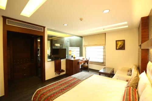 a hotel room with a bed and a living room at Hotel Icon in Chandīgarh