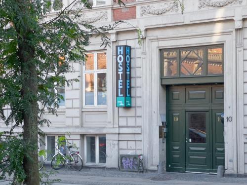 a building with a green door on a street at where to sleep in Copenhagen