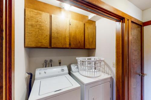 a laundry room with a washing machine and cabinets at Tahoe Enchantment in Zephyr Cove