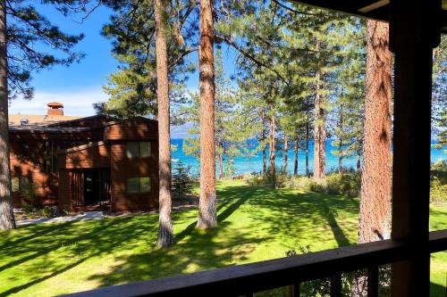 a view from the porch of a cabin with trees at Tahoe Enchantment in Zephyr Cove