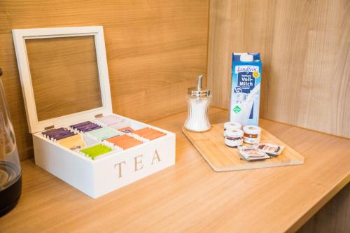 a toy laptop on a table with a box of tea at Auszeit im Schwarzwald in Lenzkirch