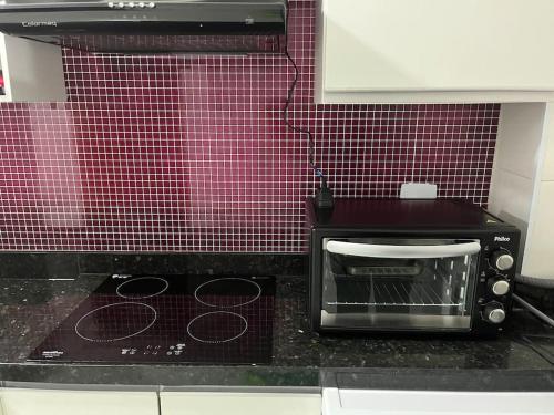 a toaster oven sitting on a counter in a kitchen at Novo apartamento Smart em São Paulo Pirituba in Sao Paulo