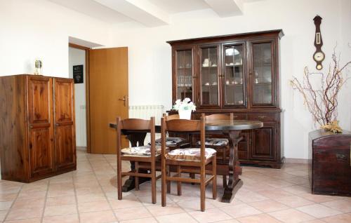a dining room with a table and some wooden cabinets at La Casa di Grazia in Ronciglione